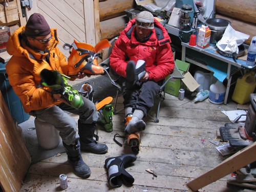 Two telemark skiers trying to decide which Alpine Touring boot will work best.  This image of Armond (left) sitting on a one-gallon propane cylinder in front of a wood stove always brings a smile to my face.